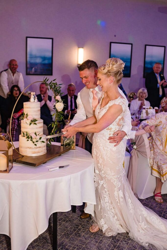 bride and groom cutting cake at wedding venue northampton