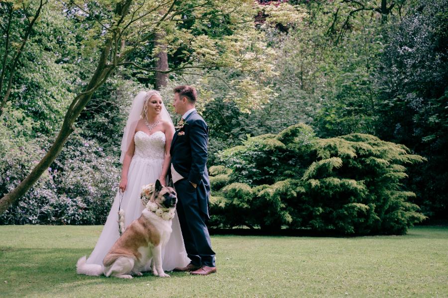 bride and groom and their dog in wedding garden Sedgebrook Hall